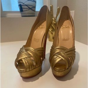 Beautiful Christian Louboutin gold heels there in good condition.